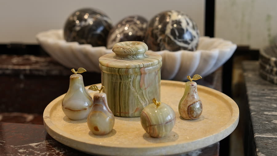 Onyx fruit and canister. Onyx pears, an apple and a lidded canister on a marble tray.