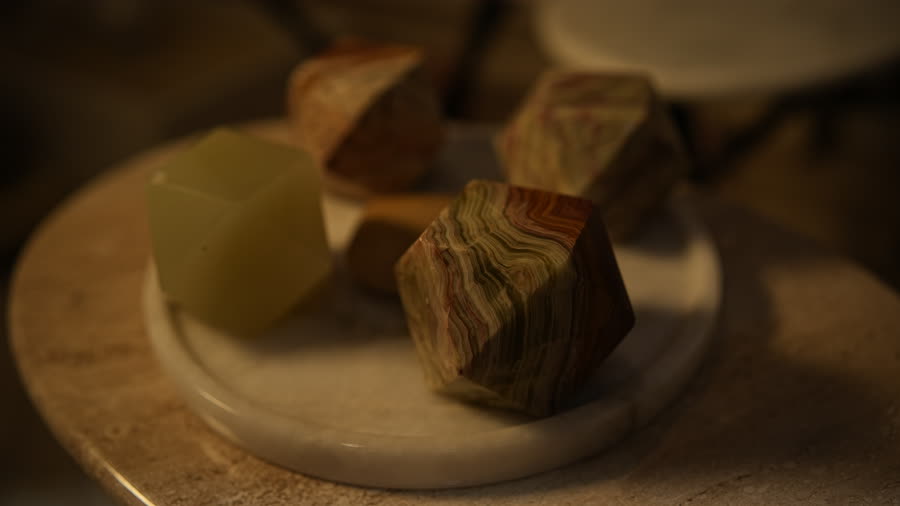 Onyx cubes. Faceted onyx cubes on a marble plate.