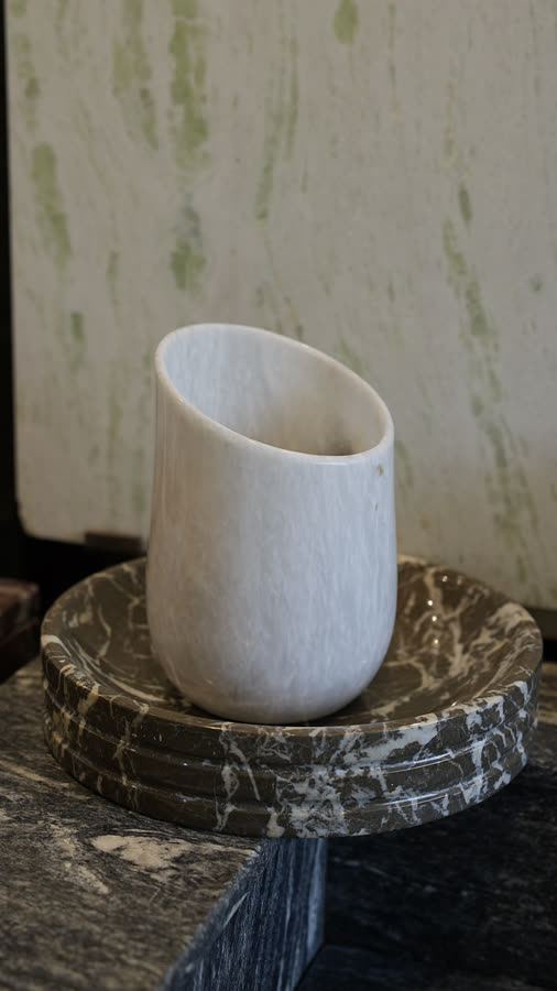 Marble cup. White marble cup on a black marble coaster stack.